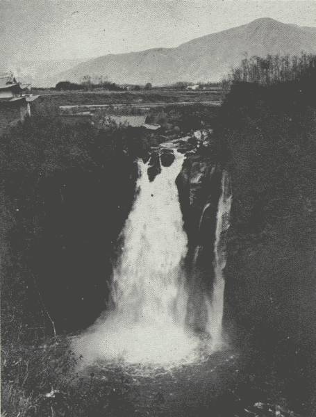 THE TENGYUEH WATERFALL

Mountains opposite are about 4,000 feet higher than the Tengyueh Plain,
which is about 5,500 feet; over this waterfall one of author's ponies
"committed suicide," Chinese said.