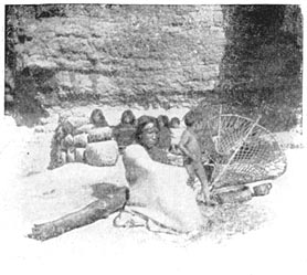 Tarahumares Sunning Themselves. In the foreground is seen an implement for carrying burdens on the back.