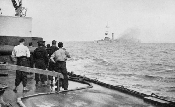 photo men watching ship sink