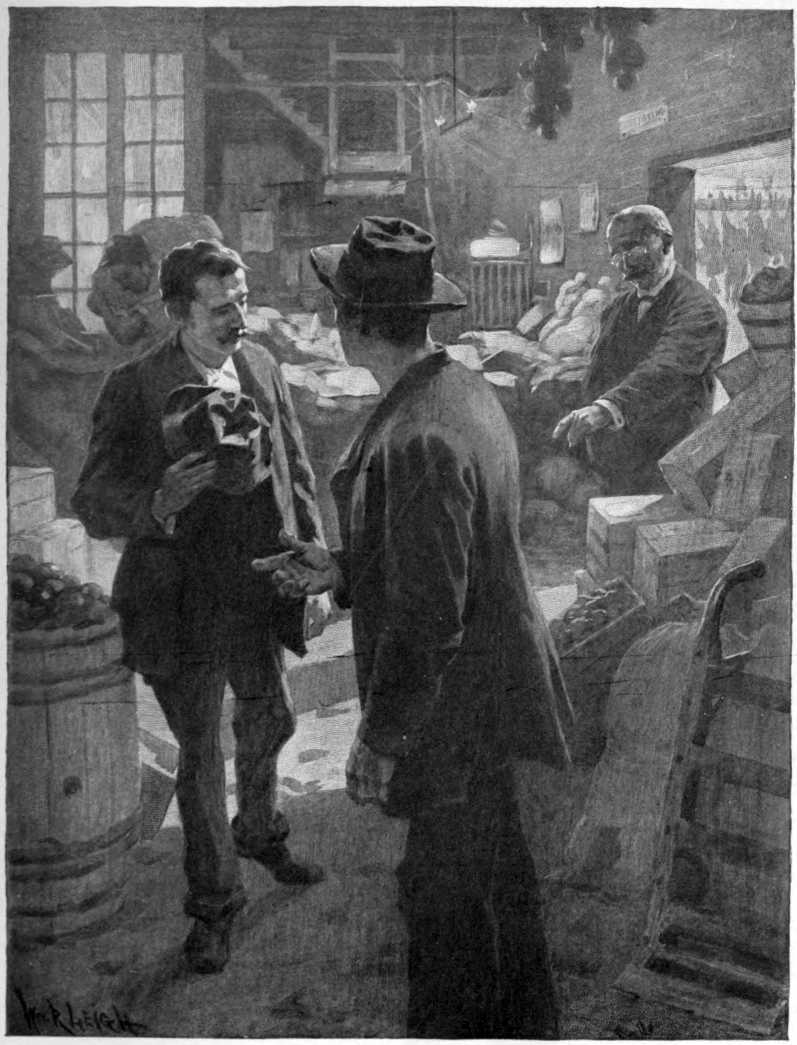In a warehouse one well dressed man is pointing at two poorly dressed men.