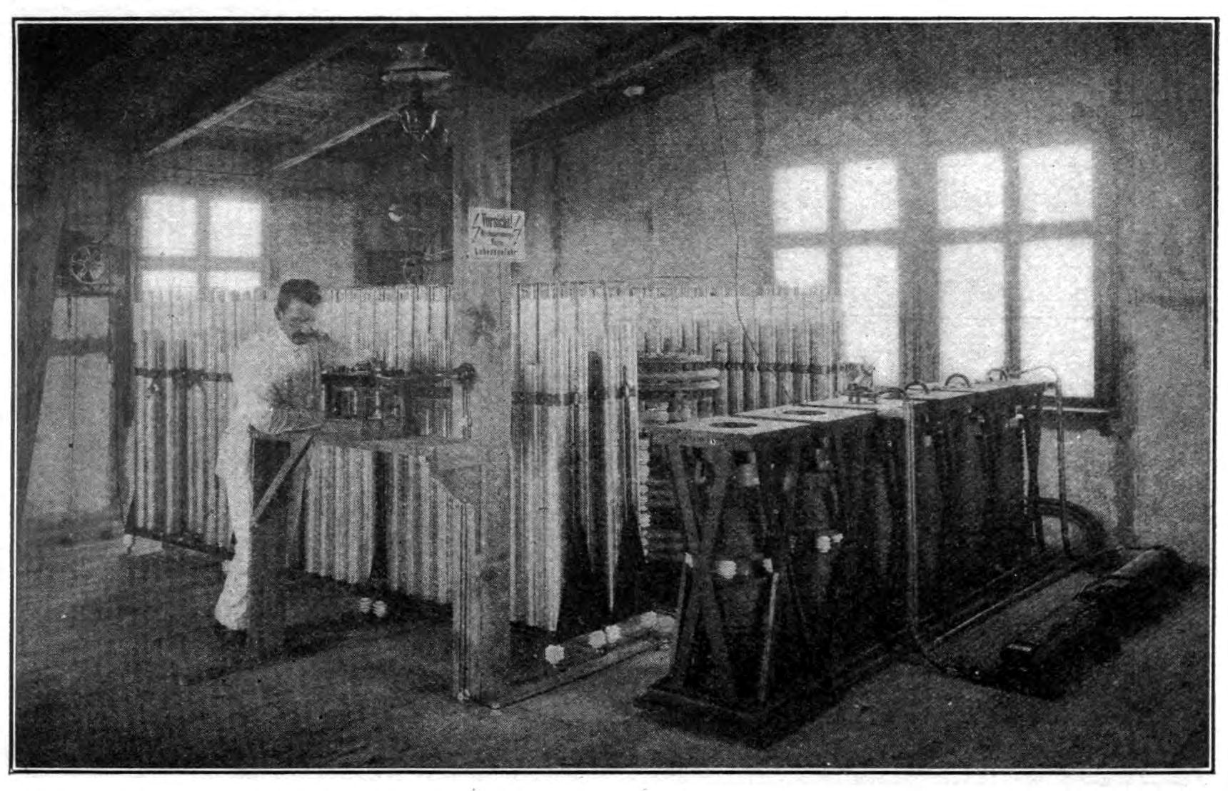 FIG. 116.—Transmitting equipment of the high power station at Nauen, twenty-five miles northwest of Berlin, Germany, showing six induction coils (in the foreground) arranged to charge the Leyden jars (composed of 360 units).