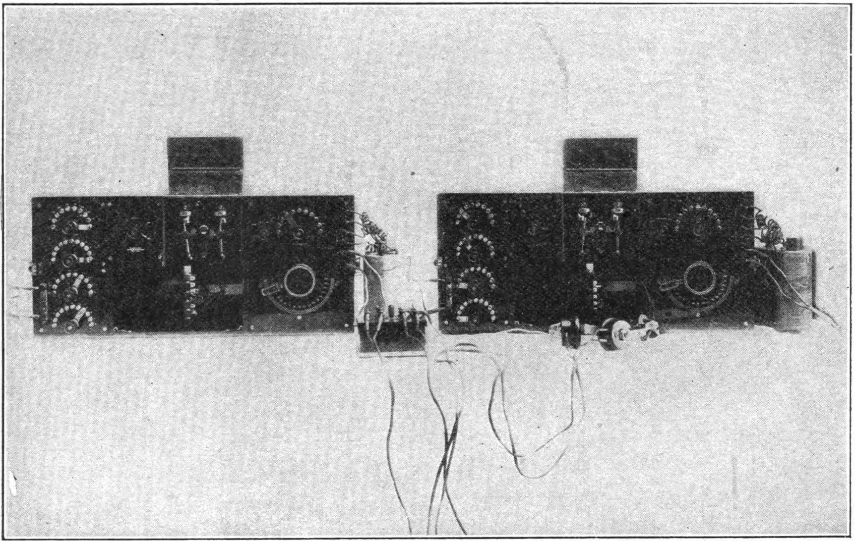 FIG. 117.—Duplex receiving apparatus. The set to the left may be adjusted to receive short wave lengths and that to the right to receive long waves. When the handle of the "listening" key, shown in the center of the illustration, is in the center, the left hand phone of the head set is connected to the instruments on the left and the right hand phone to those on the right, so that the operator is always ready to receive either short or long waves if received. Swinging the key connects both phones to either set at will.