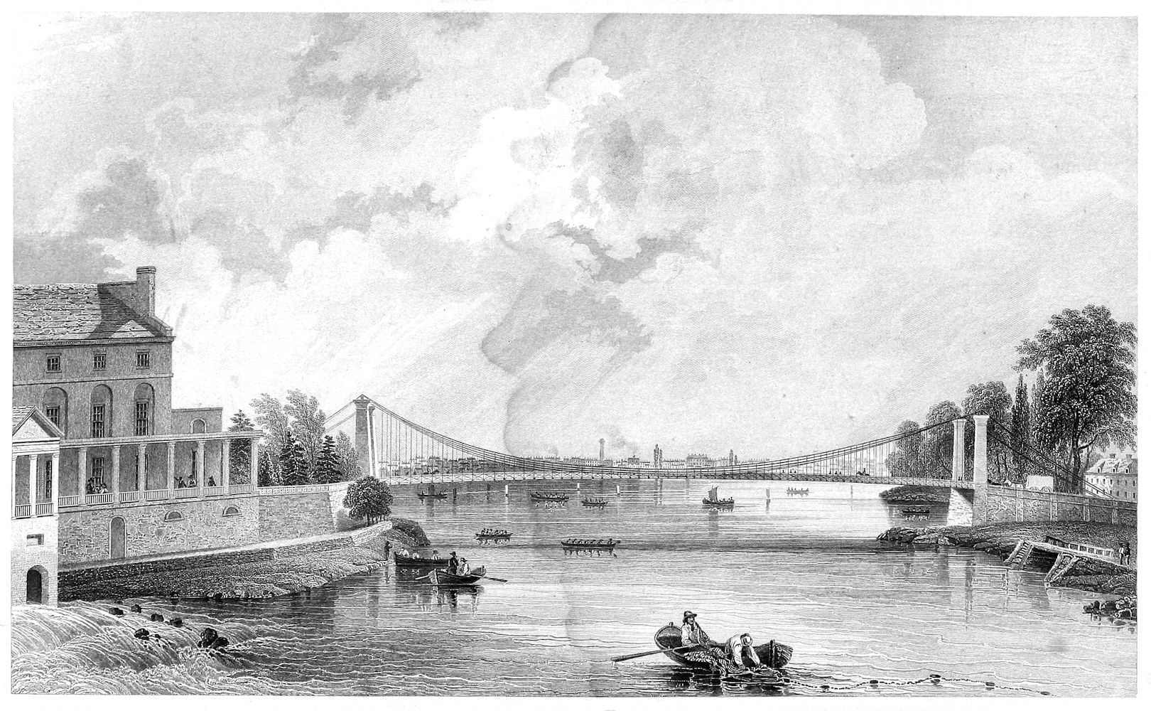 view of a suspension bridge with various boats in the water